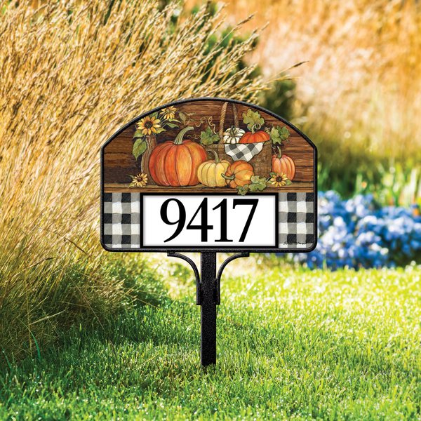 Autumn pumpkin yard sign in a fall garden