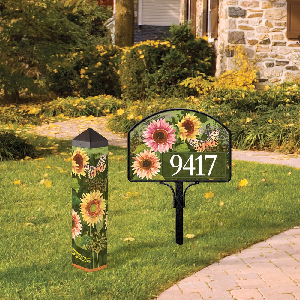Autumn yard signs and art poles lining a garden path