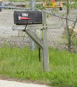 Bungee Mailbox This mailbox is holding on for dear life. Thank goodness for the bungee cord!